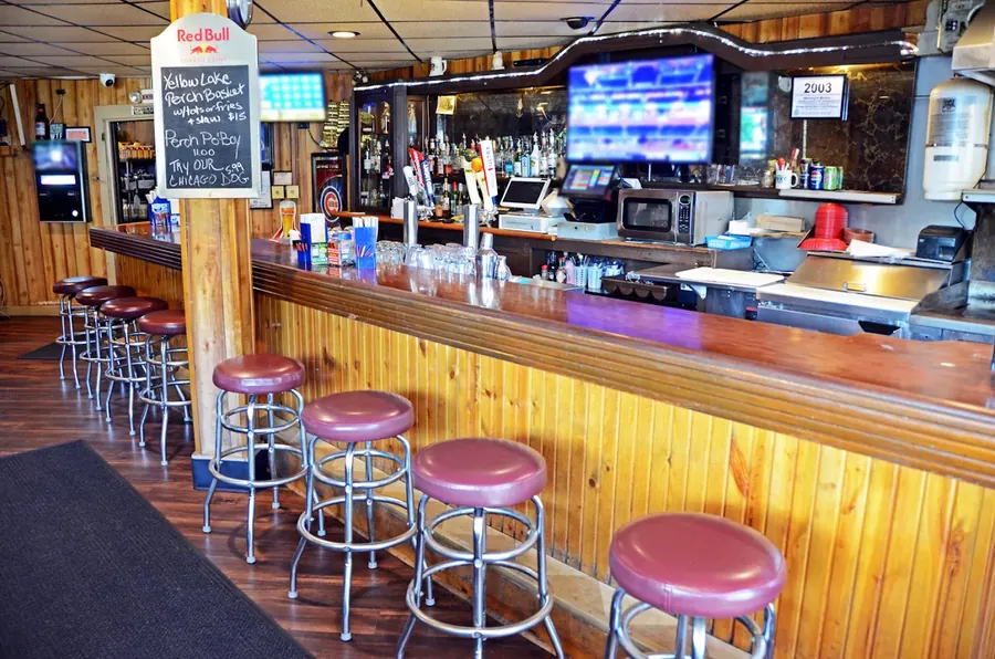 Main bar at Grand Crossing with the chalkboard specials board and beer taps