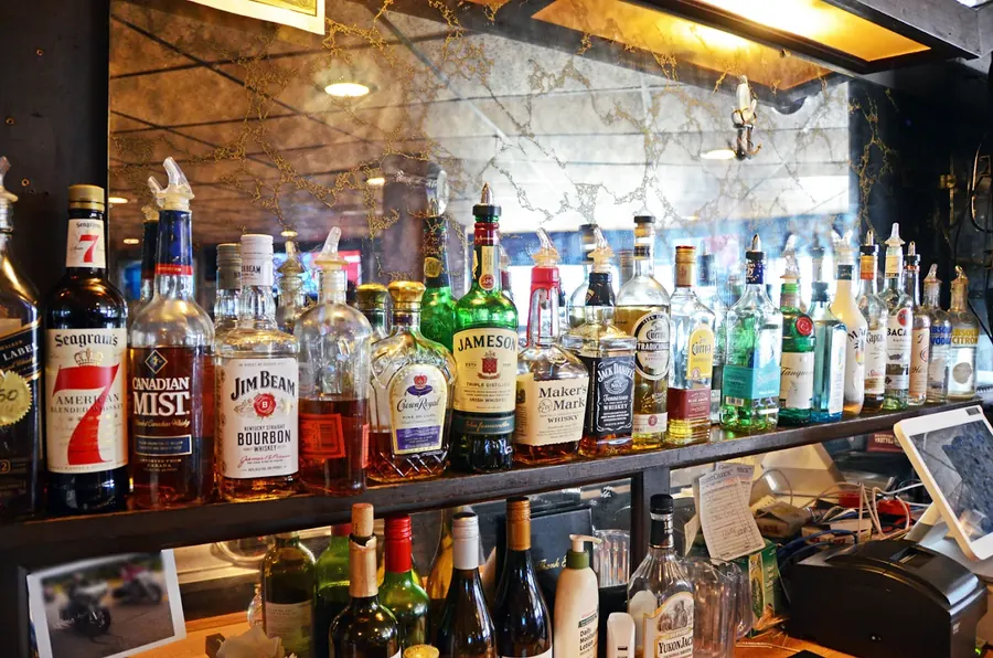 Back-bar liquor shelf at Grand Crossing with whiskey, bourbon and spirits